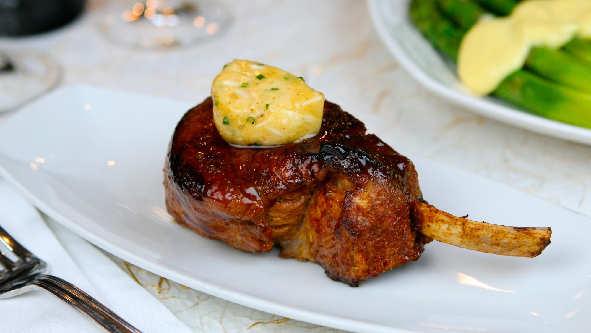 Grilled bone-in pork chop with herb butter by an Indian Wells personal chef