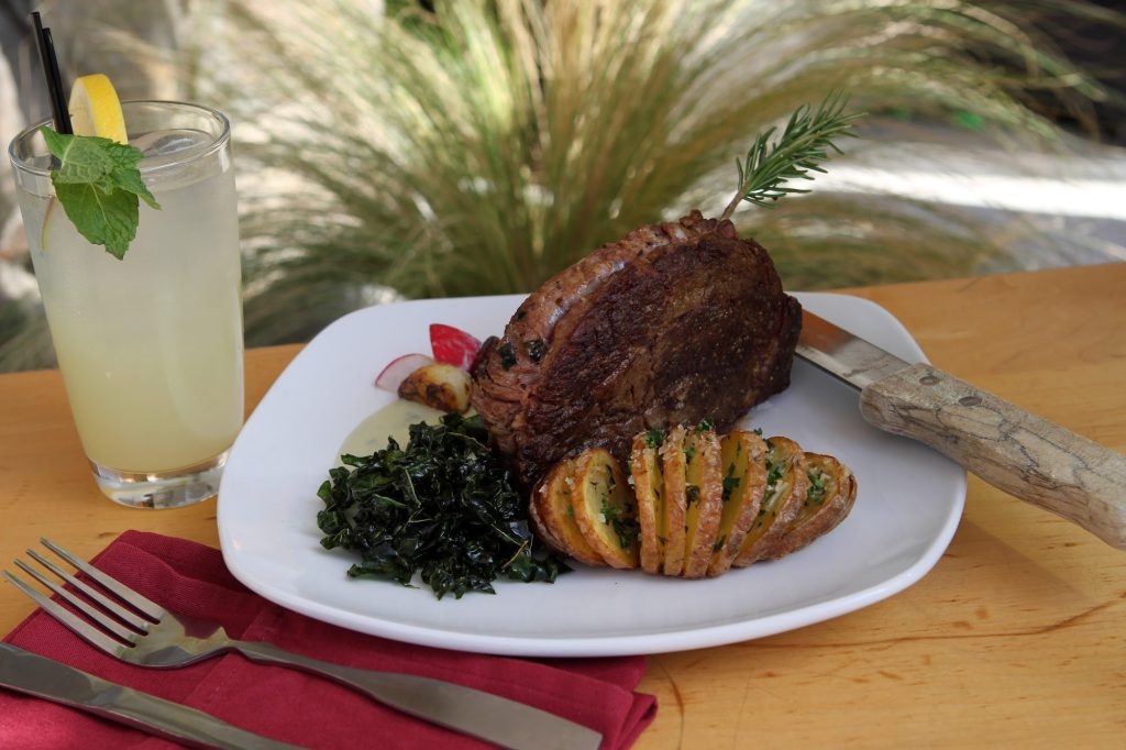 Seared steak with dressed greens, plated by a Palm Springs private chef
